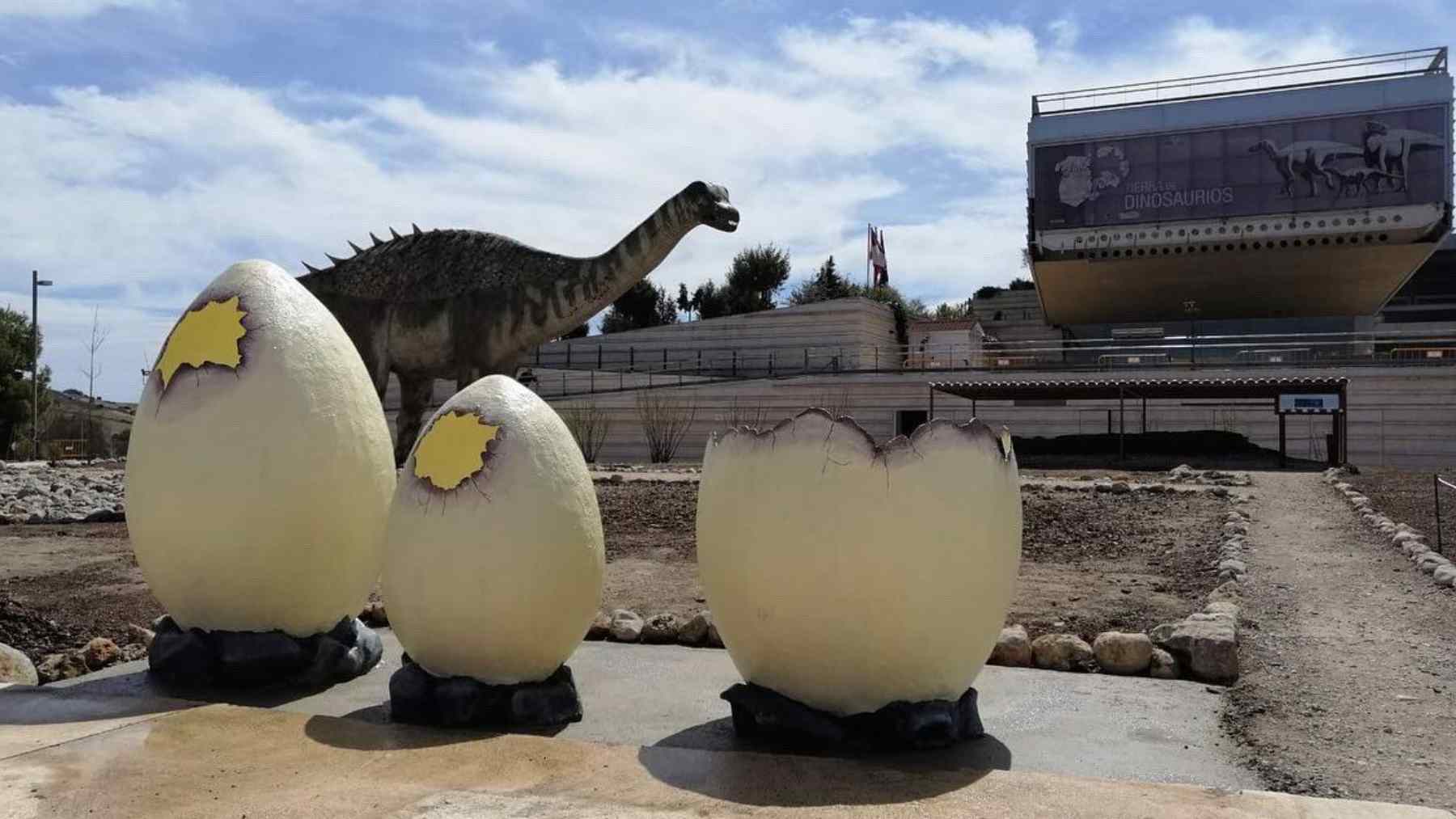 Giant dinosaur egg sculptures and a sauropod model outside Spain’s paleontology museum exhibit on titanosaur eggs