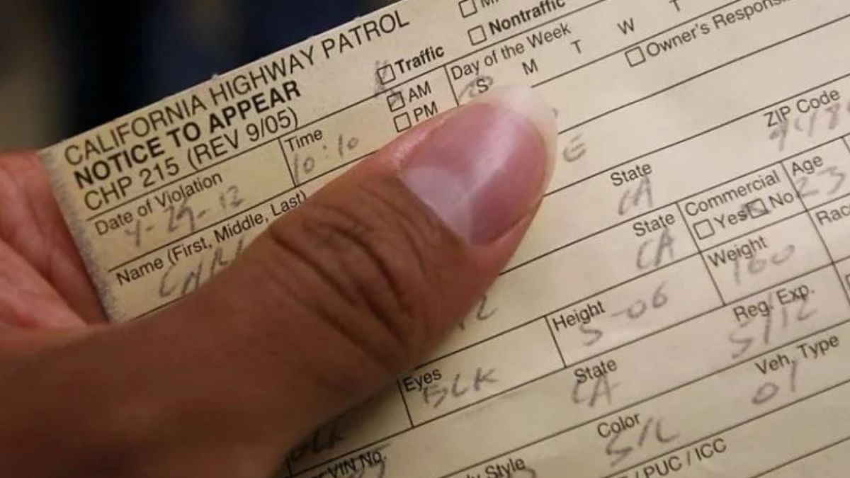 California Highway Patrol traffic ticket notice to appear held in a driver’s hand