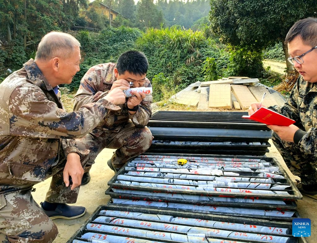 Geologists examine drill core samples from the Wangu gold field in Hunan, China