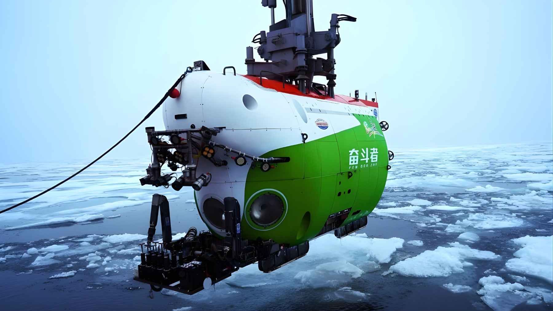 China’s Fendouzhe crewed submersible is lowered into icy Arctic waters, equipped with cameras and sampling gear for deep-sea research.
