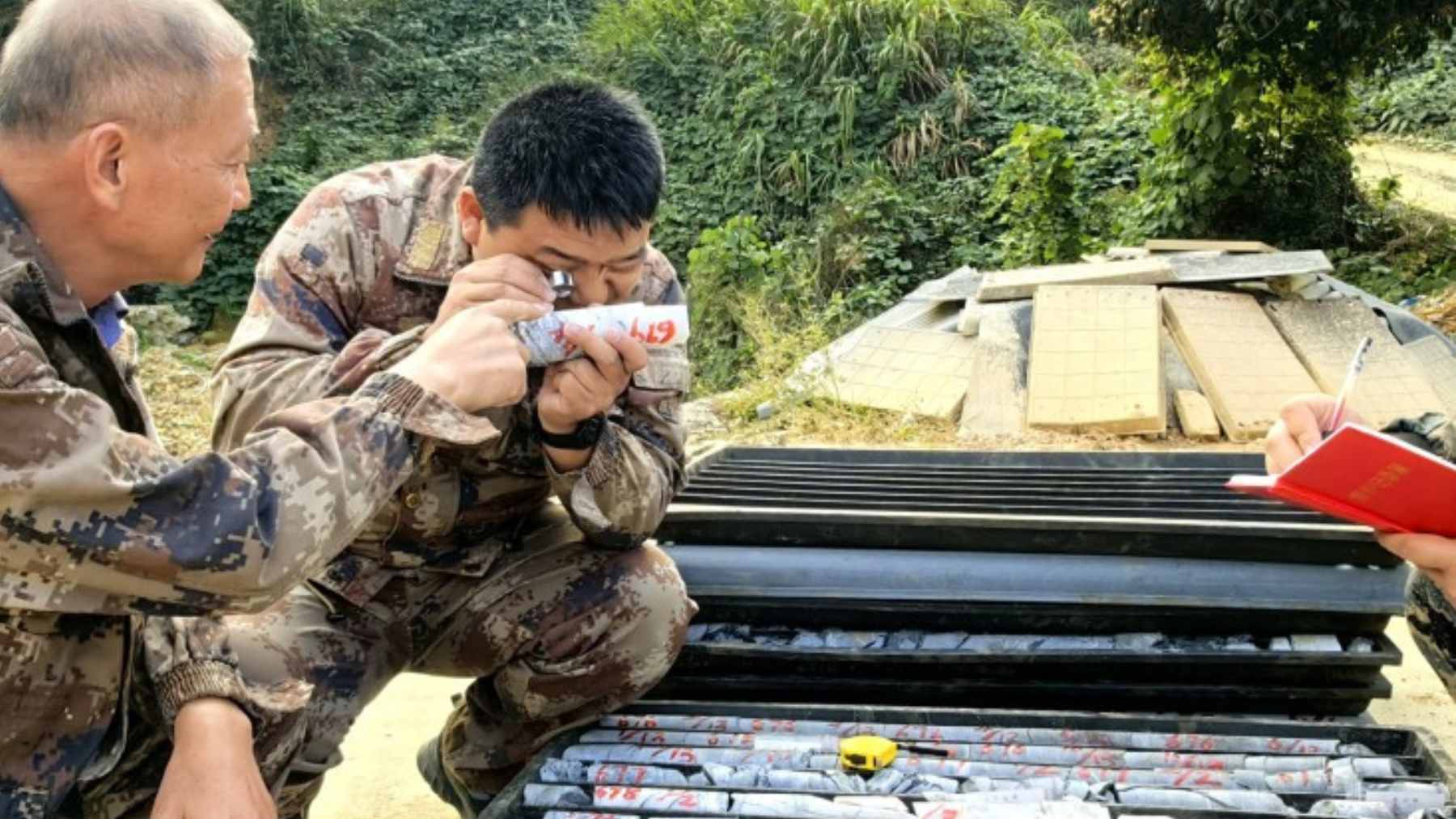 Chinese geologists examine drilled rock cores at a rural exploration site in Hunan after discovering a massive underground gold deposit.