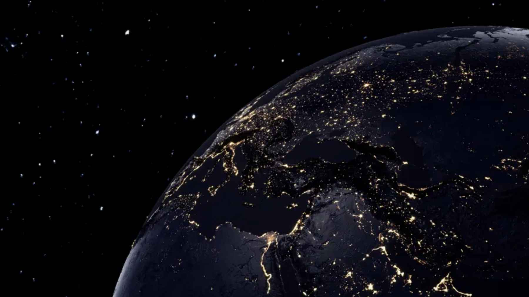 Earth at night with city lights across Europe, North Africa, and the Middle East, seen from space.