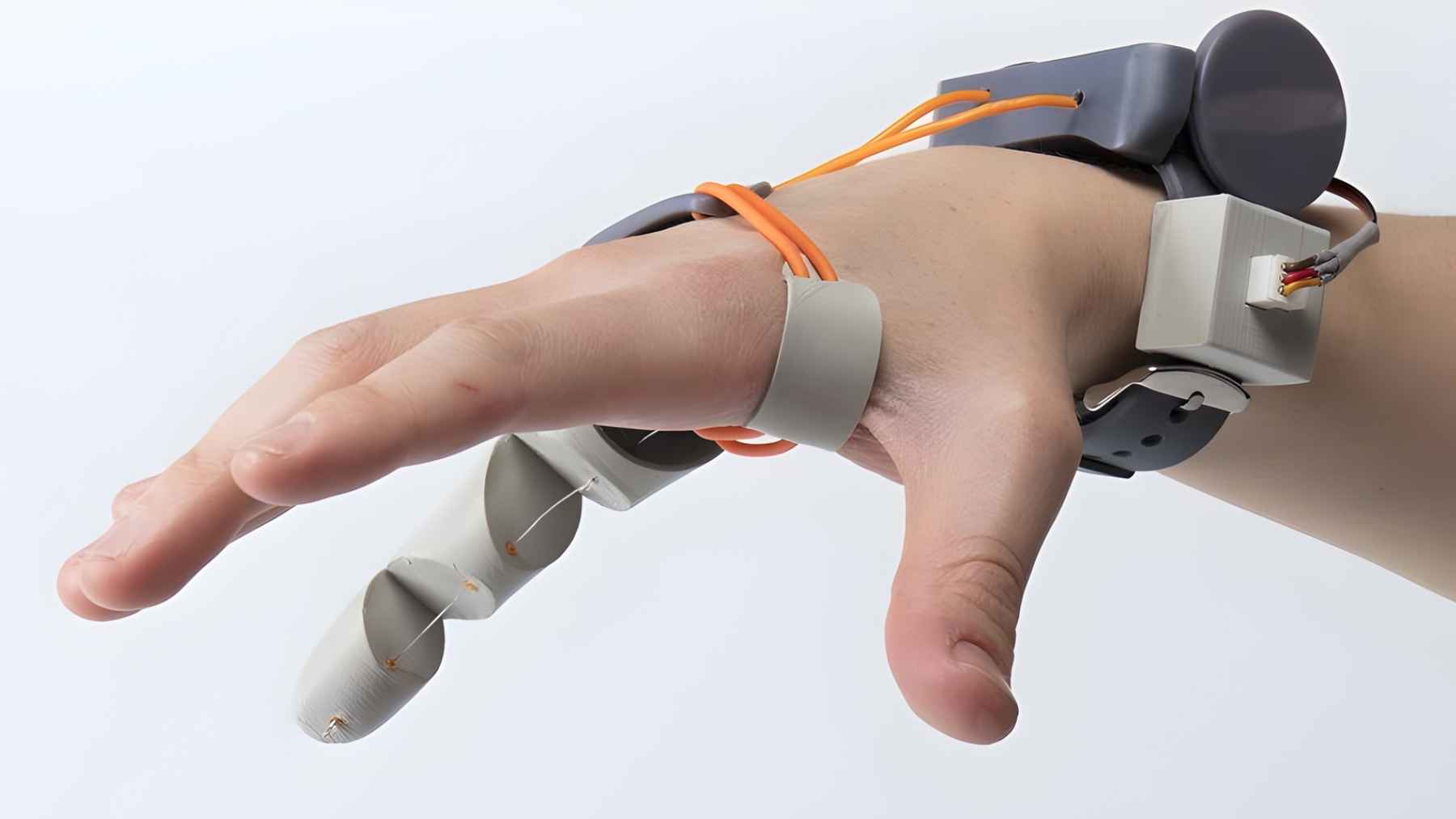 A 3D-printed robotic “Third Thumb” strapped to a hand, designed to add an extra controllable digit for gripping and dexterity.