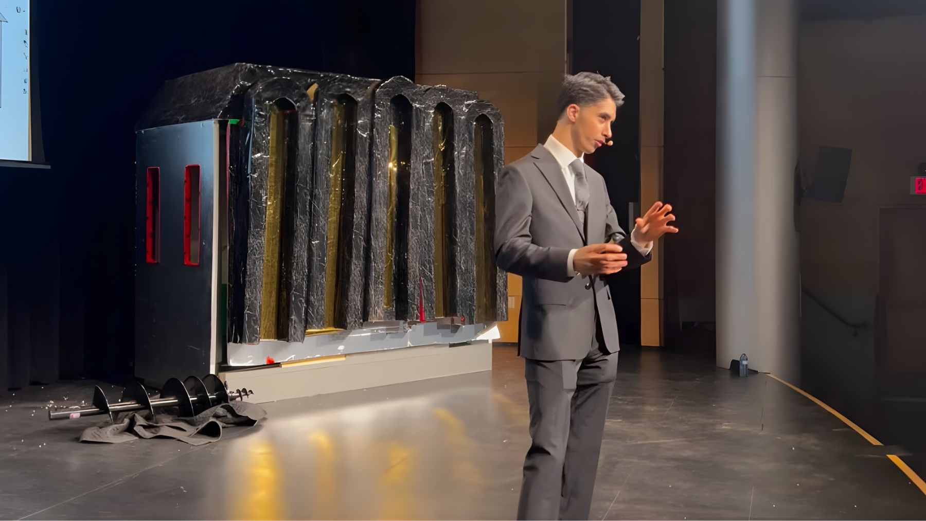 Teen engineering student inspects a compact modular micro house designed to shelter homeless people and reduce housing emissions.
