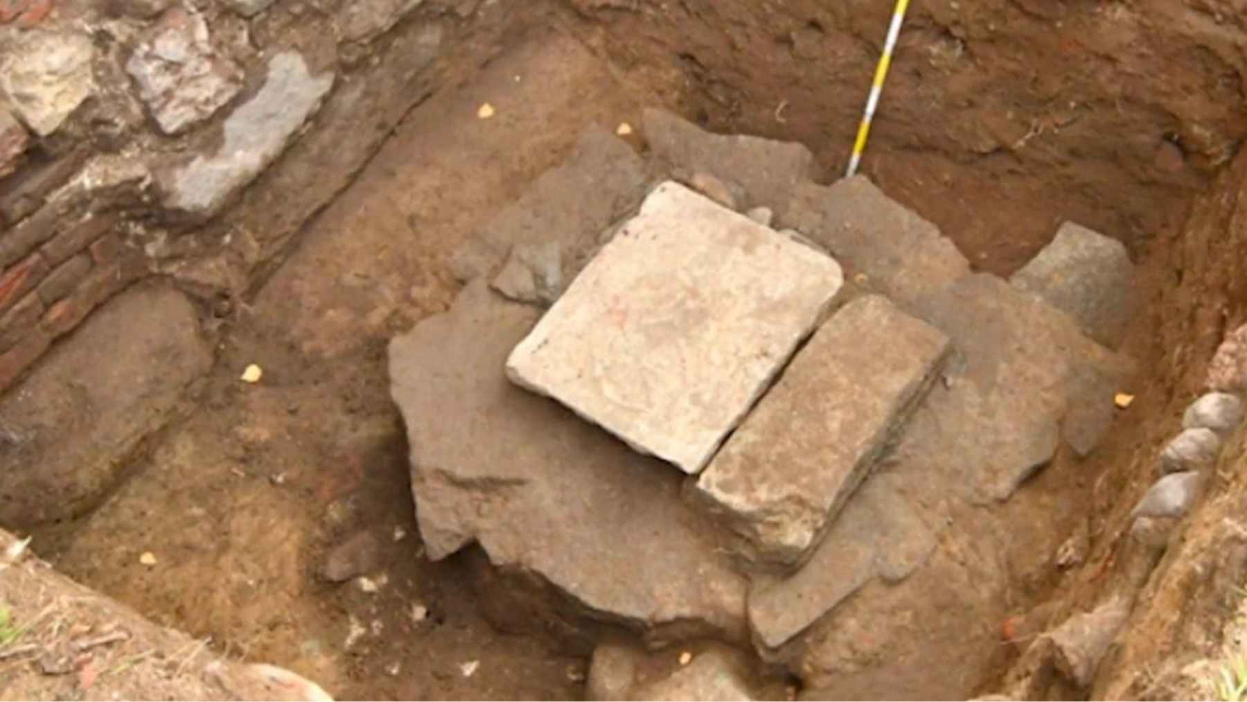 Medieval heraldic stone slab discovered beneath an old building during sewer repairs in Vyborg, Russia