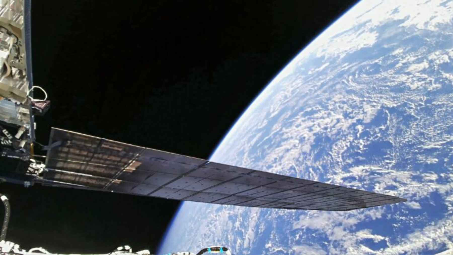 Amazon Leo internet satellites in low Earth orbit reflecting sunlight and creating bright streaks in the night sky.