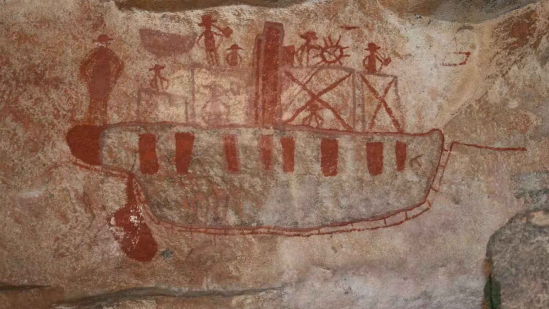 Ancient Aboriginal rock art showing a large seafaring vessel with human figures in northern Australia