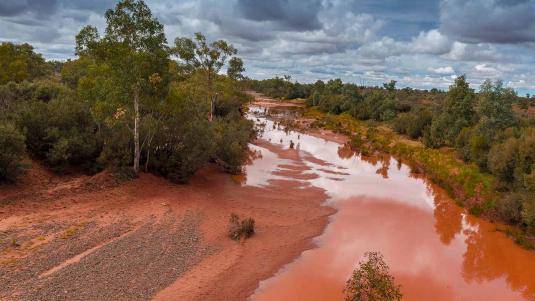 Finke (Larapinta) River in central Australia, an ancient desert river system carving through red sands near the MacDonnell Ranges