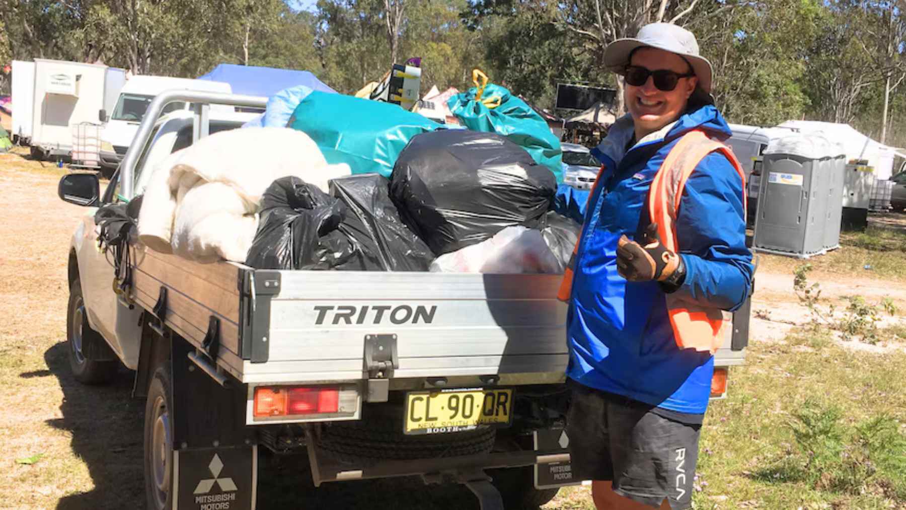 Damian Gordon stands by a pickup loaded with bags of cans and bottles collected through Australia’s Return and Earn program.