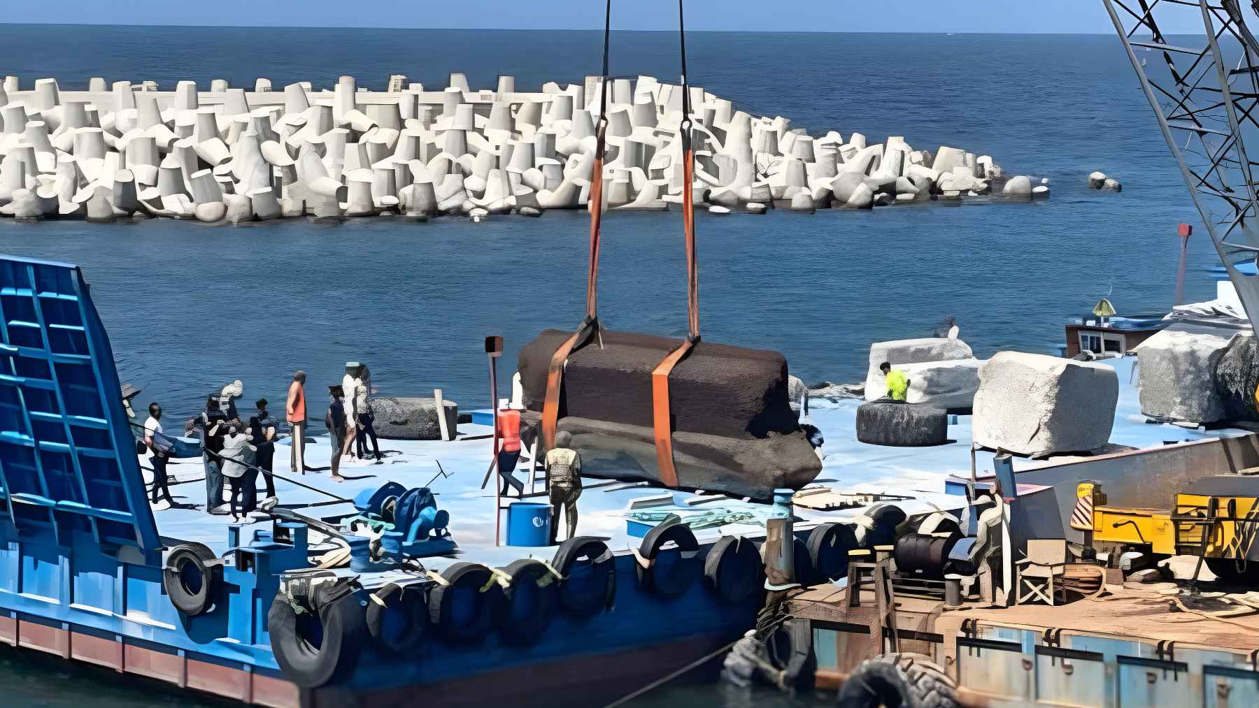 Archaeologists lifting massive stone blocks from the submerged Lighthouse of Alexandria in Egypt