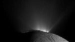 Backlit plumes erupt from Saturn’s icy moon Enceladus in a Cassini spacecraft image.