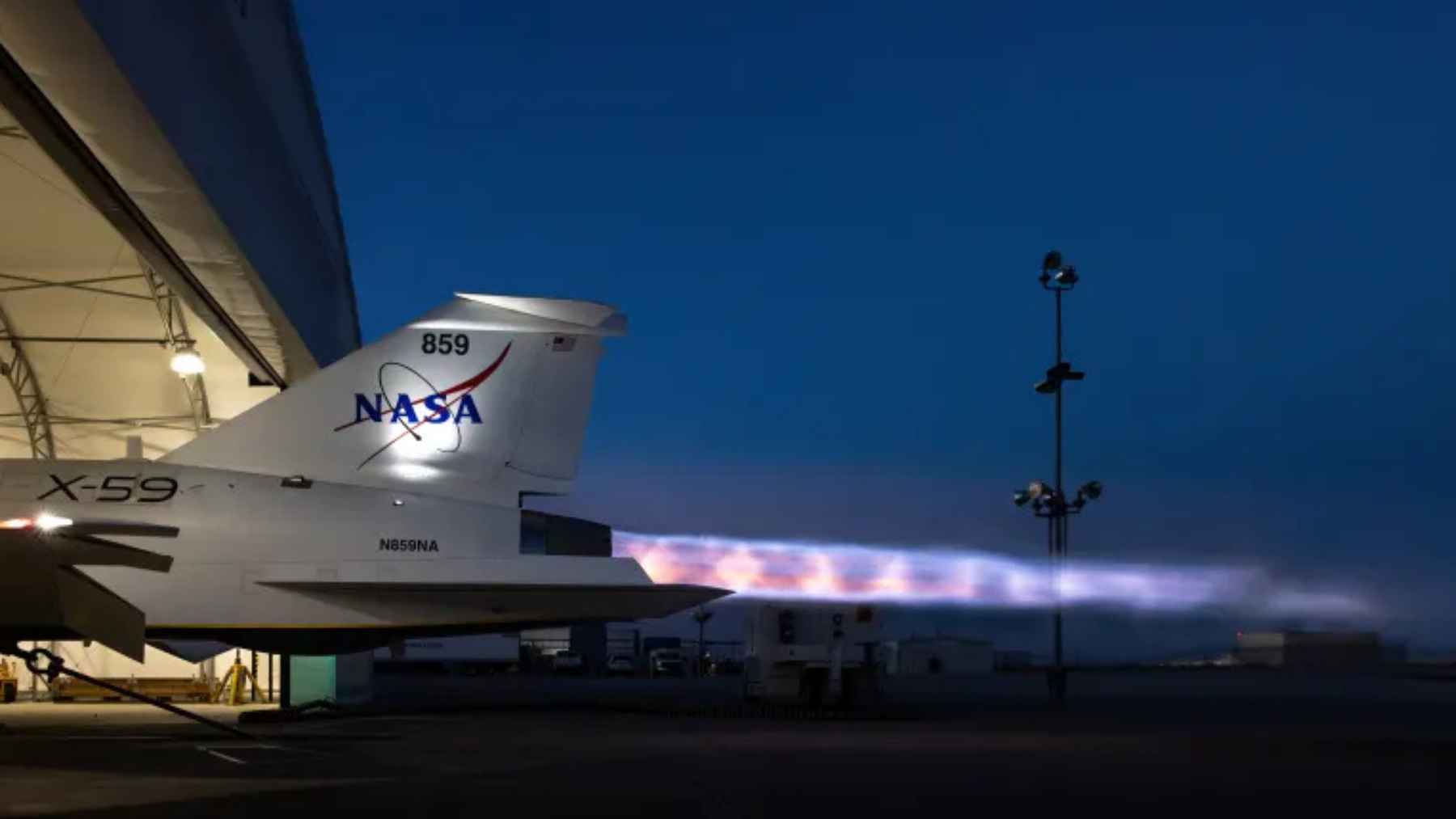 NASA’s X-59 quiet supersonic jet runs its engine at night with a bright exhaust plume during an afterburner ground test in Palmdale.