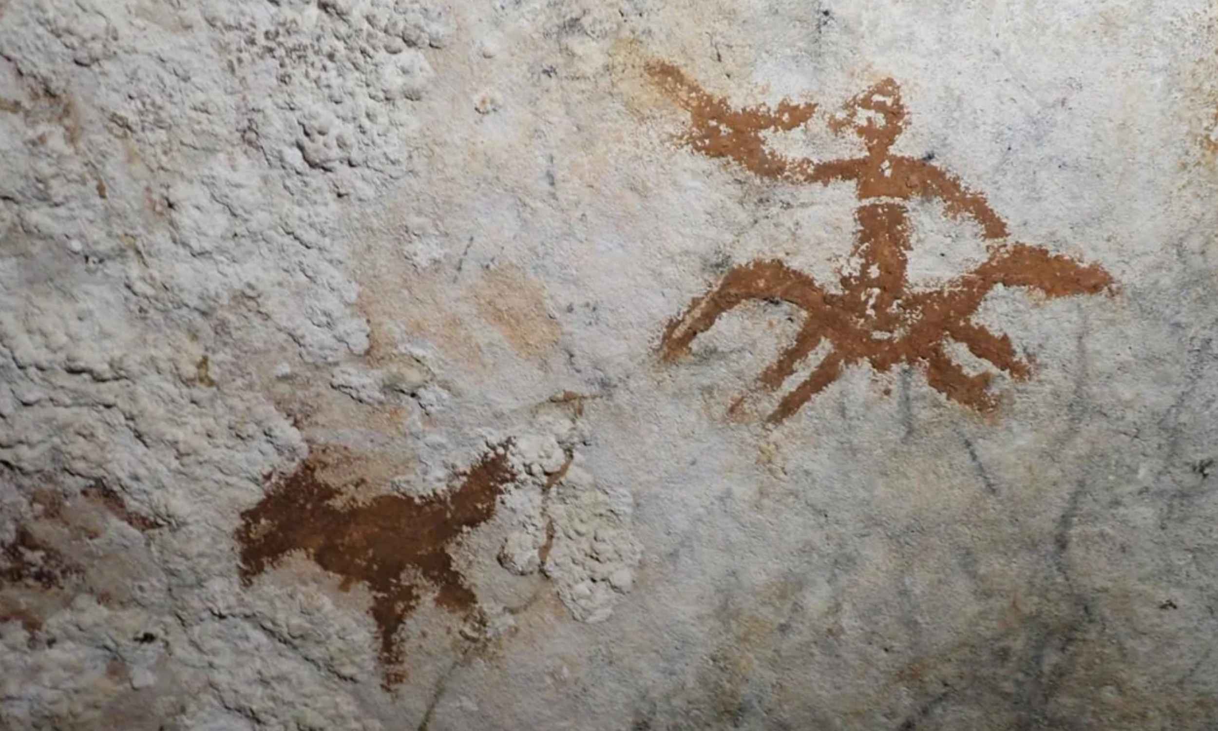 67,800 year old red hand stencil cave painting discovered in Liang Metanduno cave, Sulawesi, Indonesia