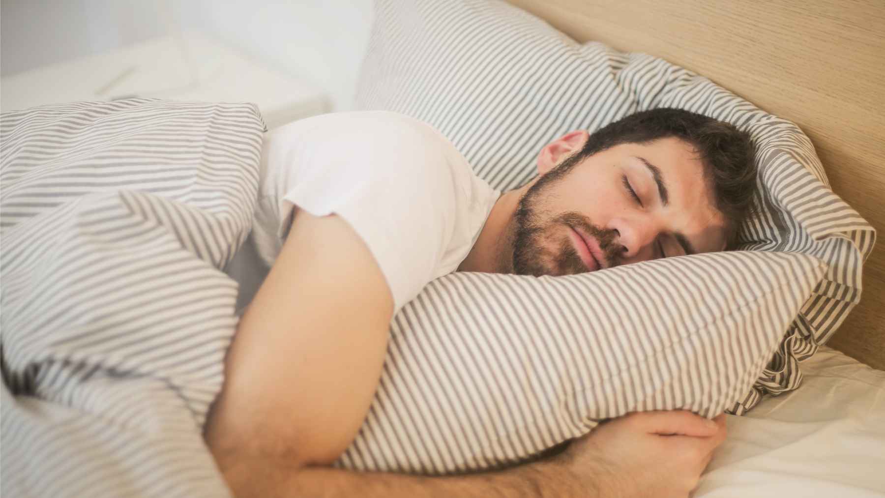Sleep deprived person lying awake at night after only four hours of rest