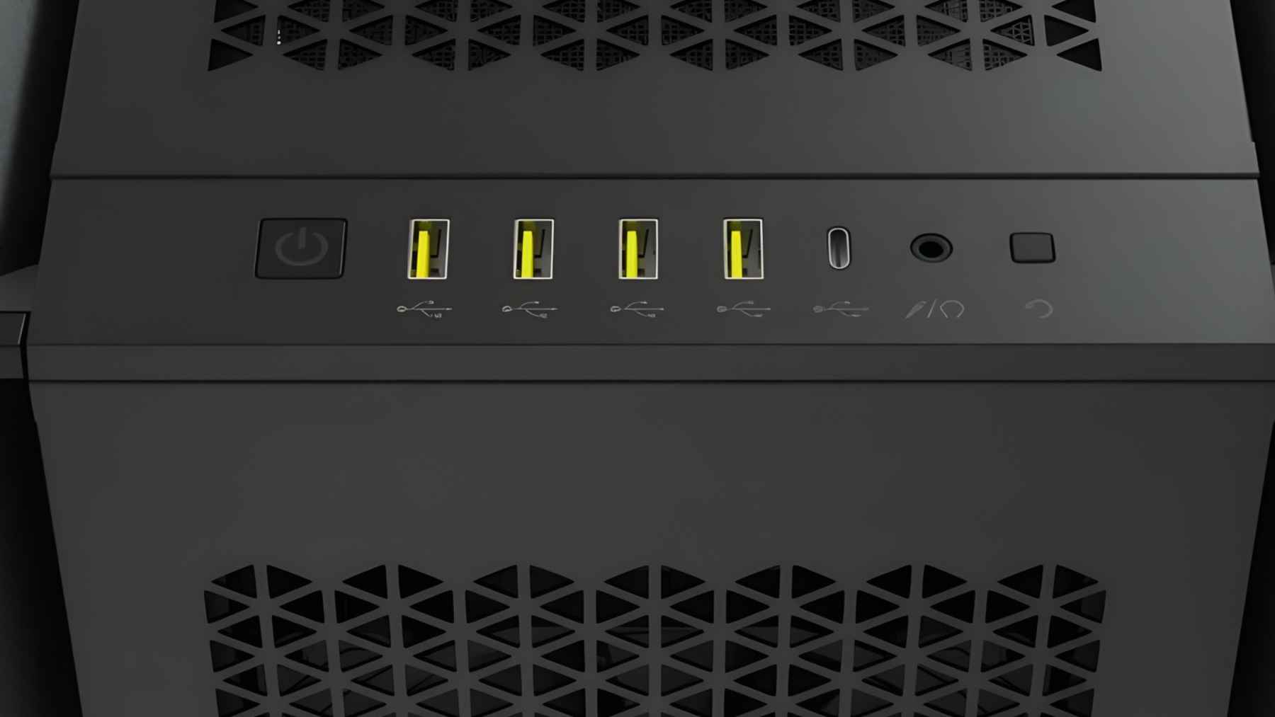 Close-up of a desktop PC front panel with yellow USB ports, power button, and audio jacks.