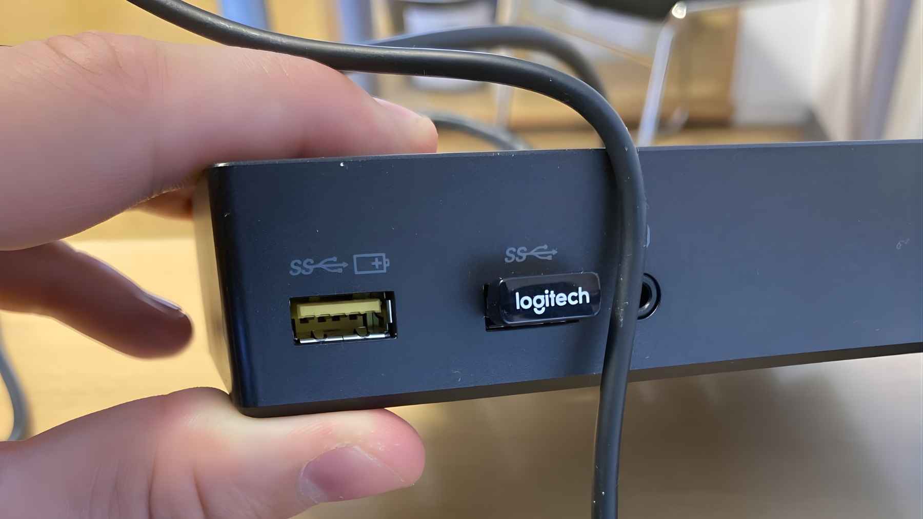 Close-up of a yellow USB port labeled for charging, next to another USB port on a device hub.