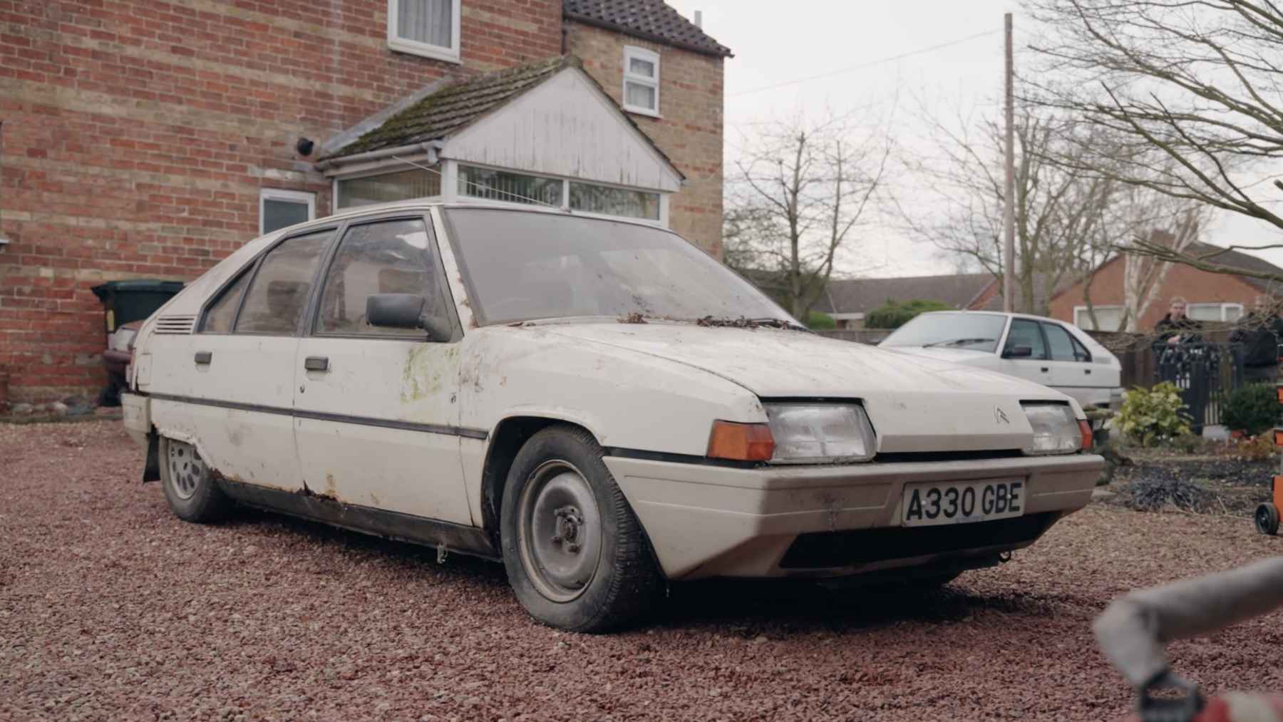 Dusty white 1983 Citroen BX parked outside a house after being stored away for nearly four decades.