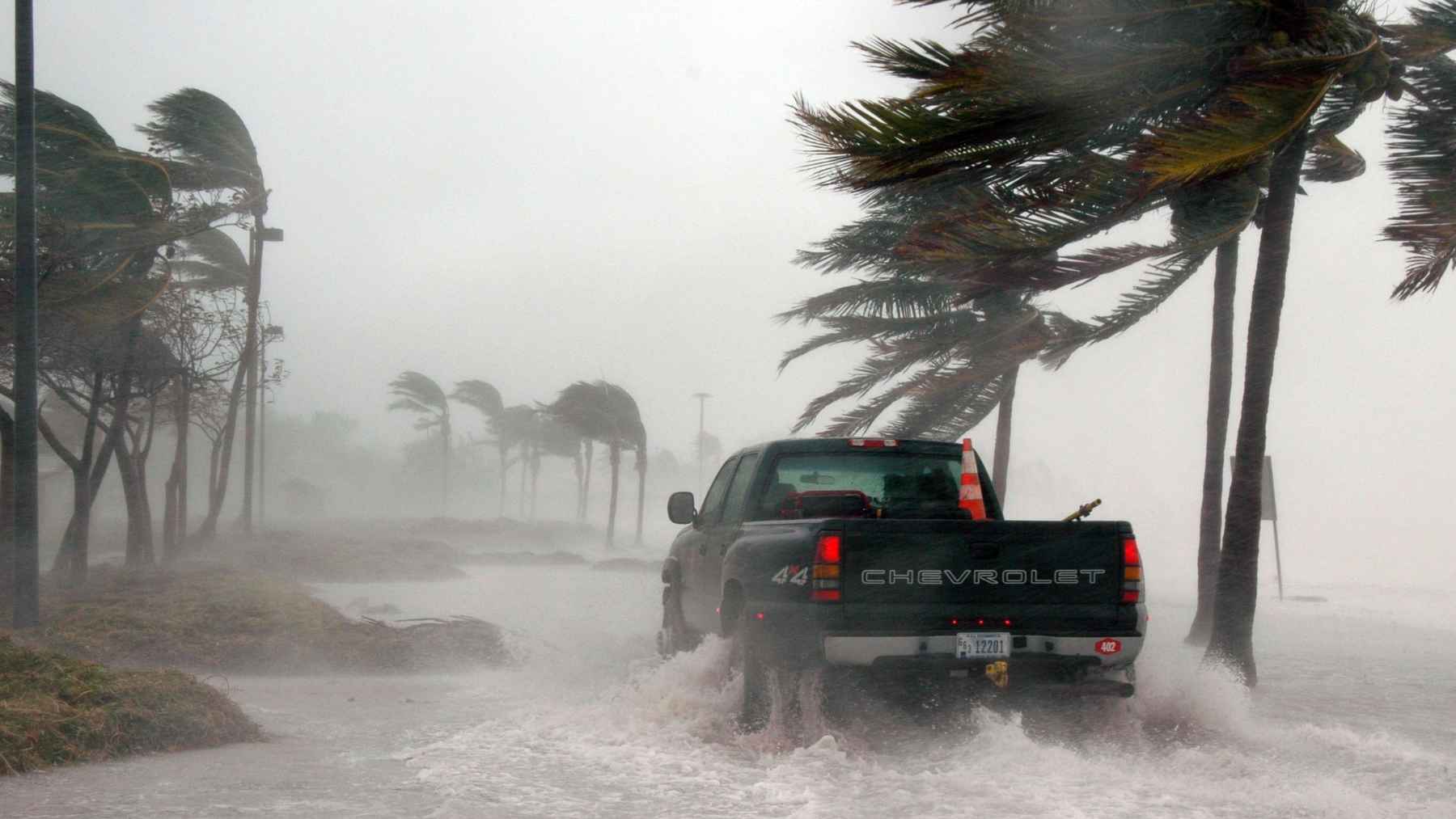 Satellite image of a powerful hurricane forming over the ocean as artificial intelligence models analyze storm development