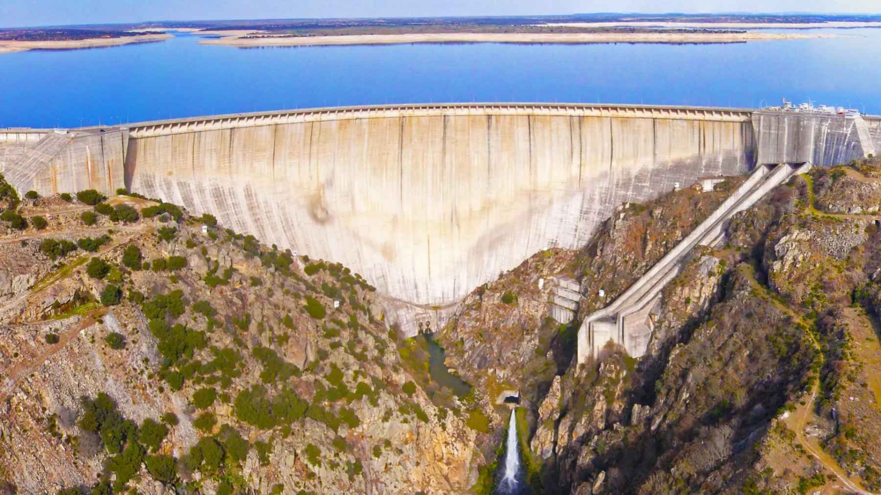 Aerial view of Spain’s Almendra Dam, a massive hydroelectric structure with a towering concrete wall above a rocky gorge
