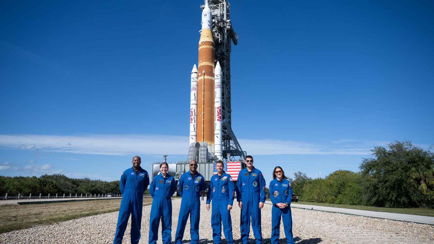 Artemis II astronauts stand in front of NASA’s Space Launch System rocket at Kennedy Space Center before the first crewed Moon mission since 1972.