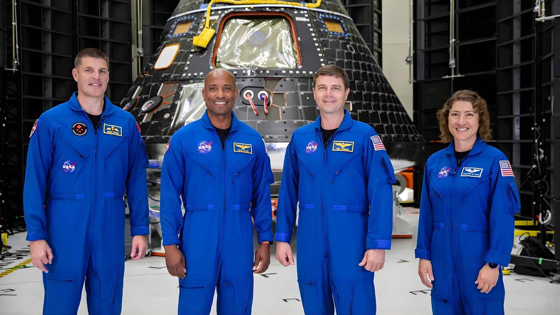 NASA Artemis II astronauts standing in front of the Orion spacecraft during preparations for the crewed mission around the Moon