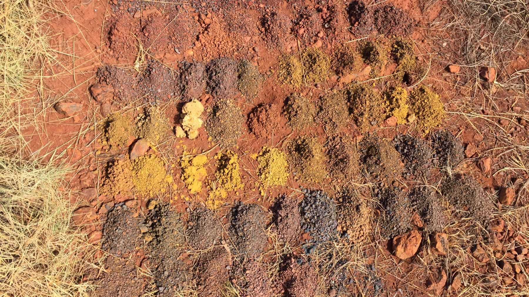 A vast open-pit iron ore mine in Western Australia's Hamersley Province, showcasing the rich red hematite deposits.