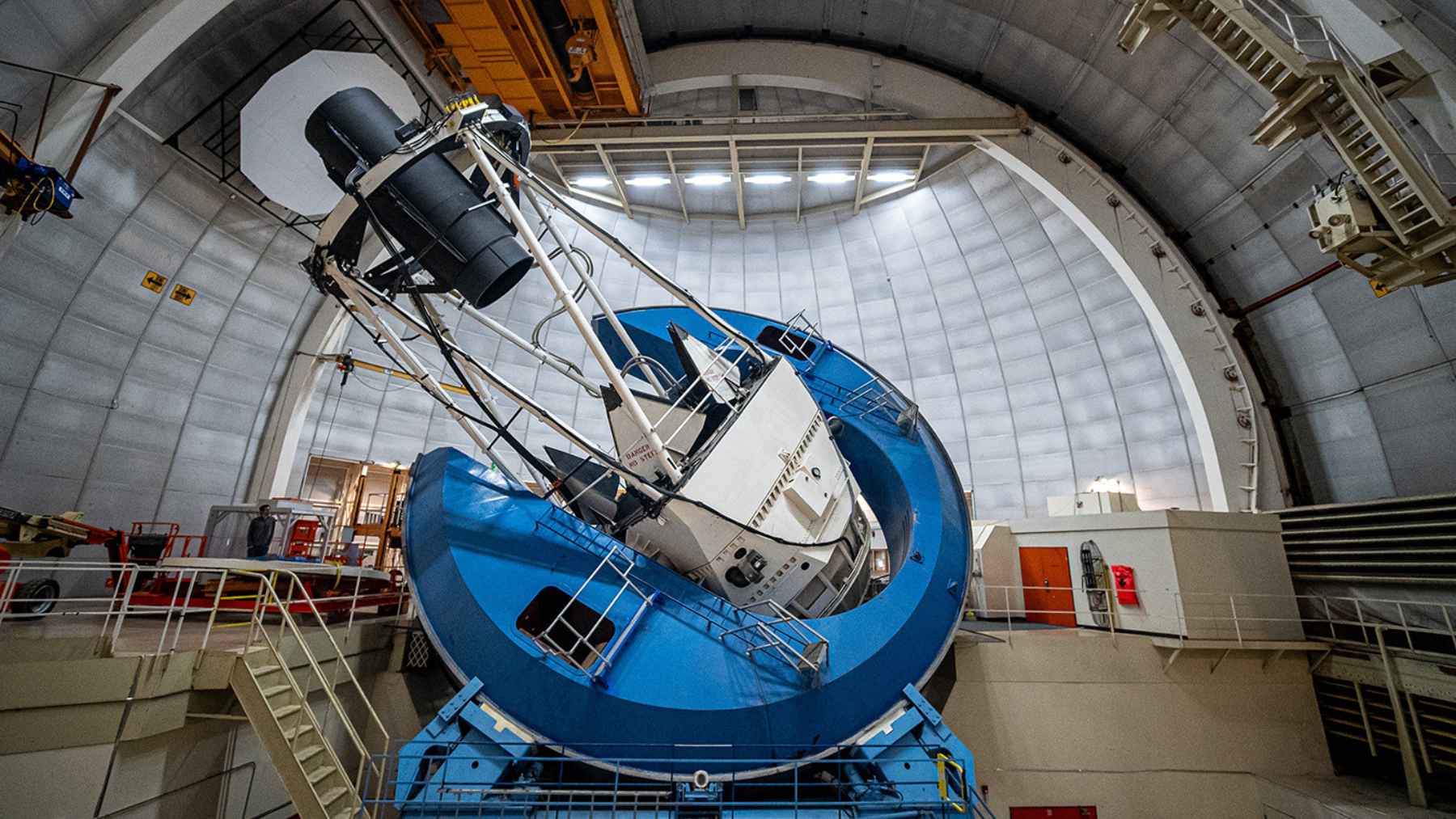 Large telescope inside an observatory dome as scientists study dark energy and the future expansion of the universe
