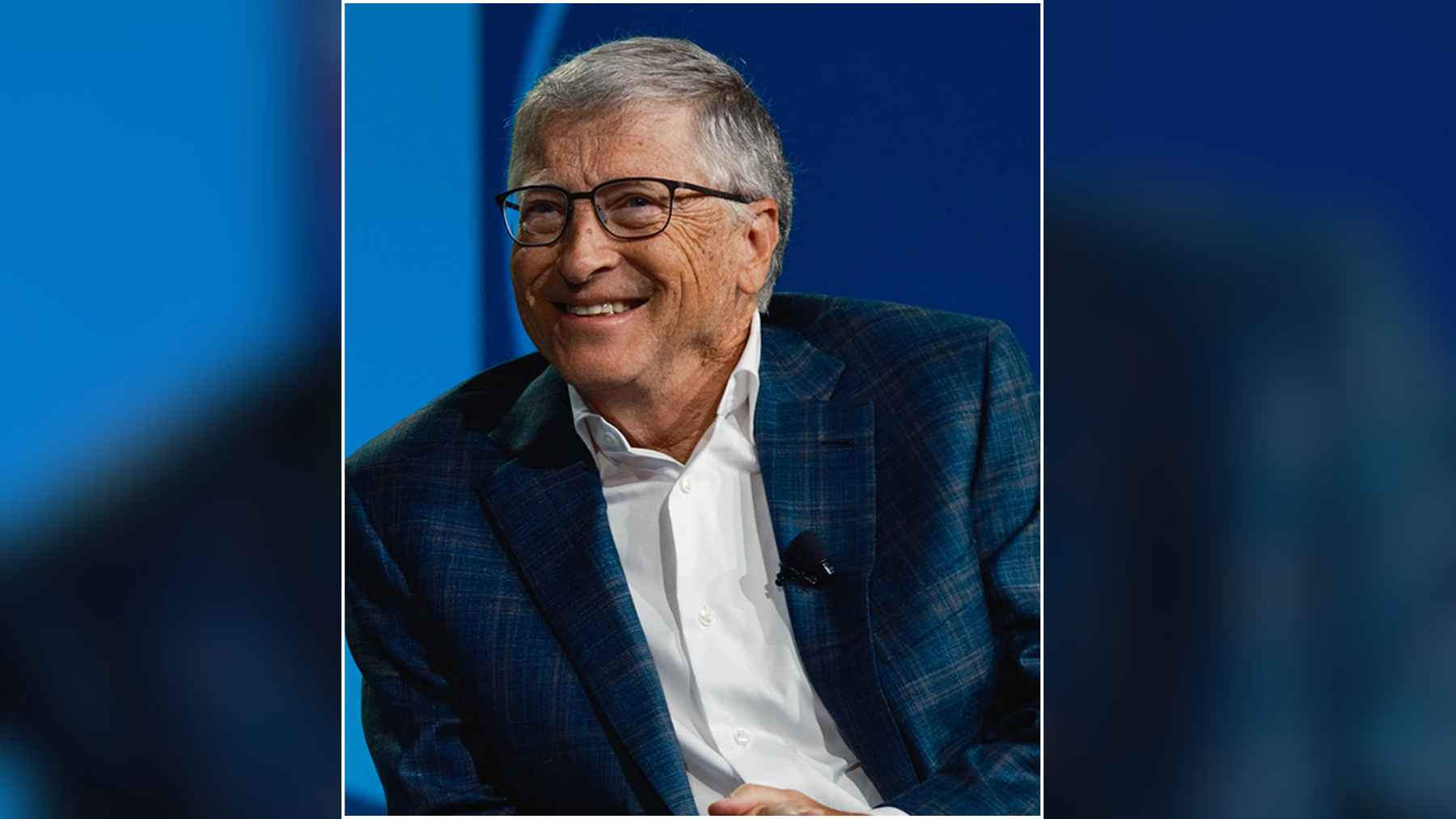 Bill Gates smiling during a public appearance, illustrating his message that steady improvements over time can lead to major change