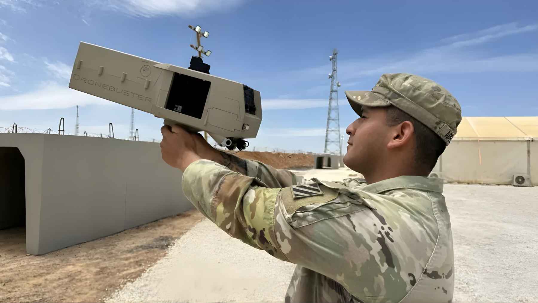 Soldier aiming a Dronebuster counter-drone device, illustrating the type of anti-drone technology used to detect or disrupt hostile drones