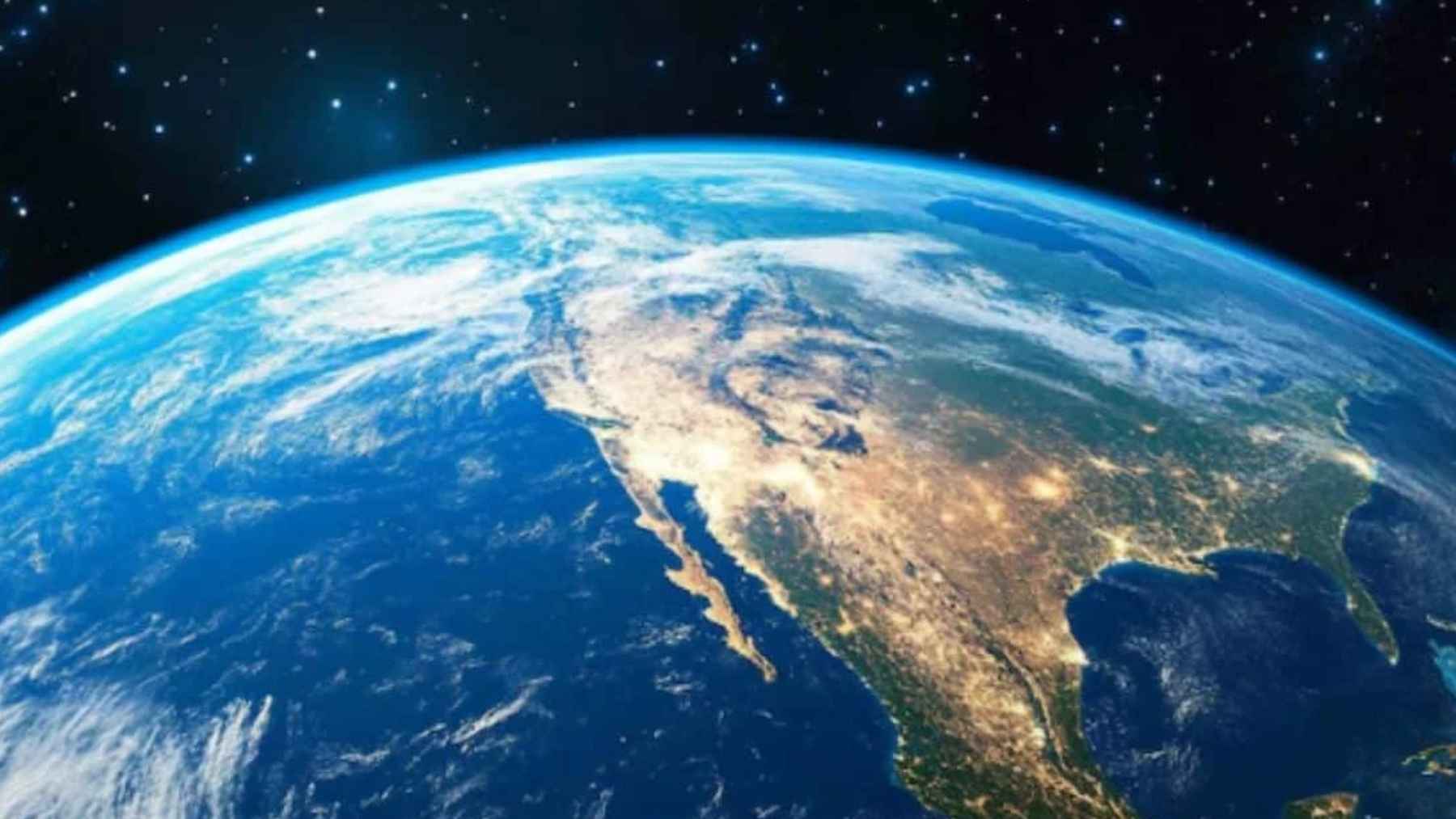 View of Earth from space showing North America, Central America, clouds, and city lights against a star-filled background