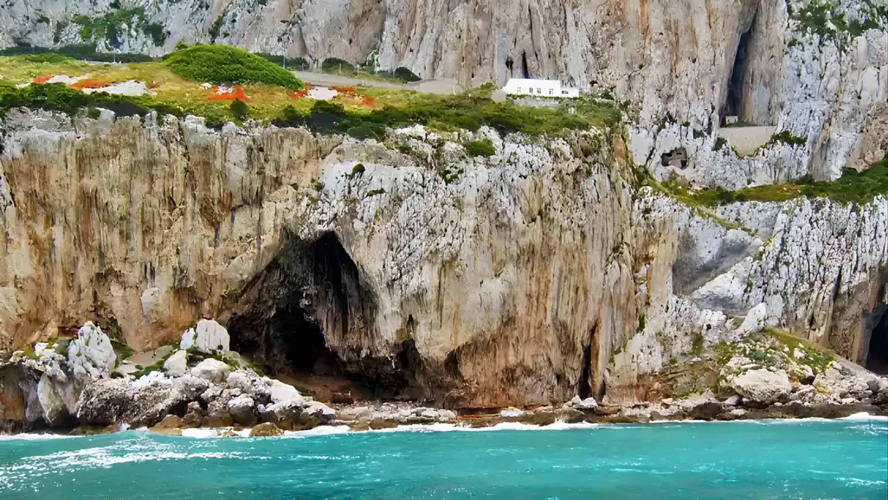 Interior of the newly discovered 13-meter chamber at the back of Vanguard Cave in Gibraltar, showing ancient sediment layers and rock formations.
