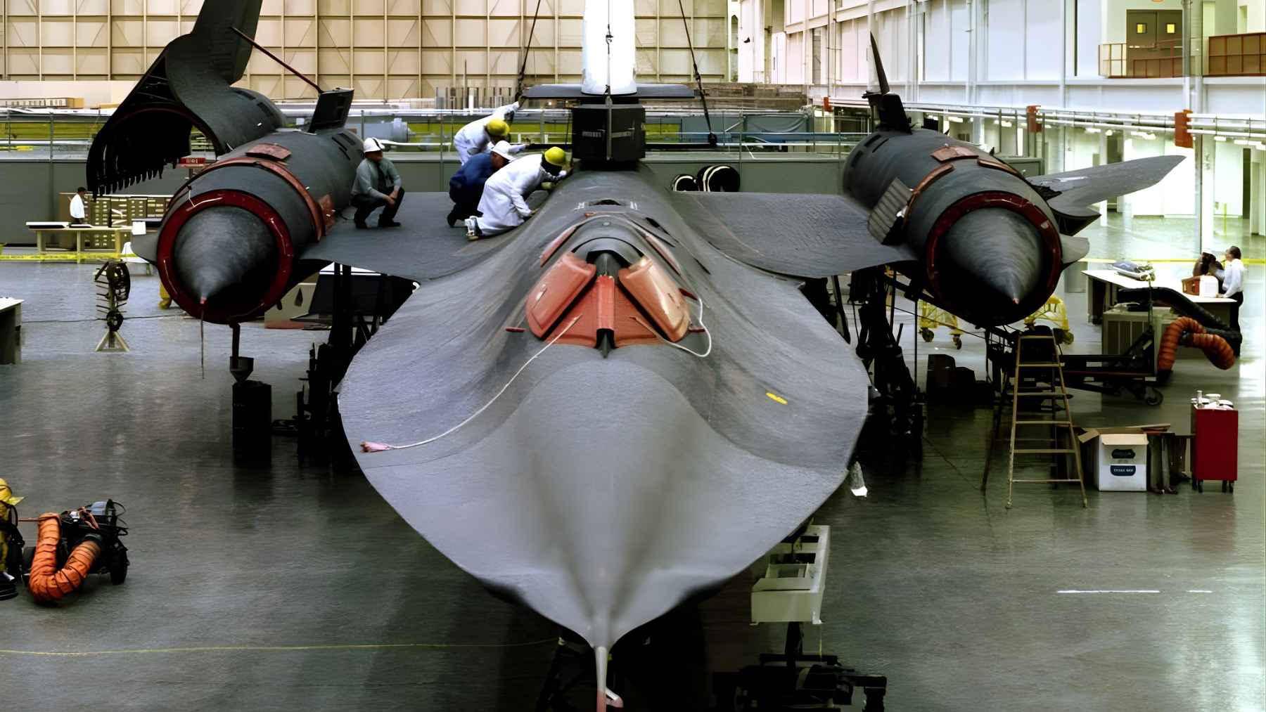 SR-71 Blackbird inside a hangar during maintenance, showing the legendary high-speed spy plane from the front.