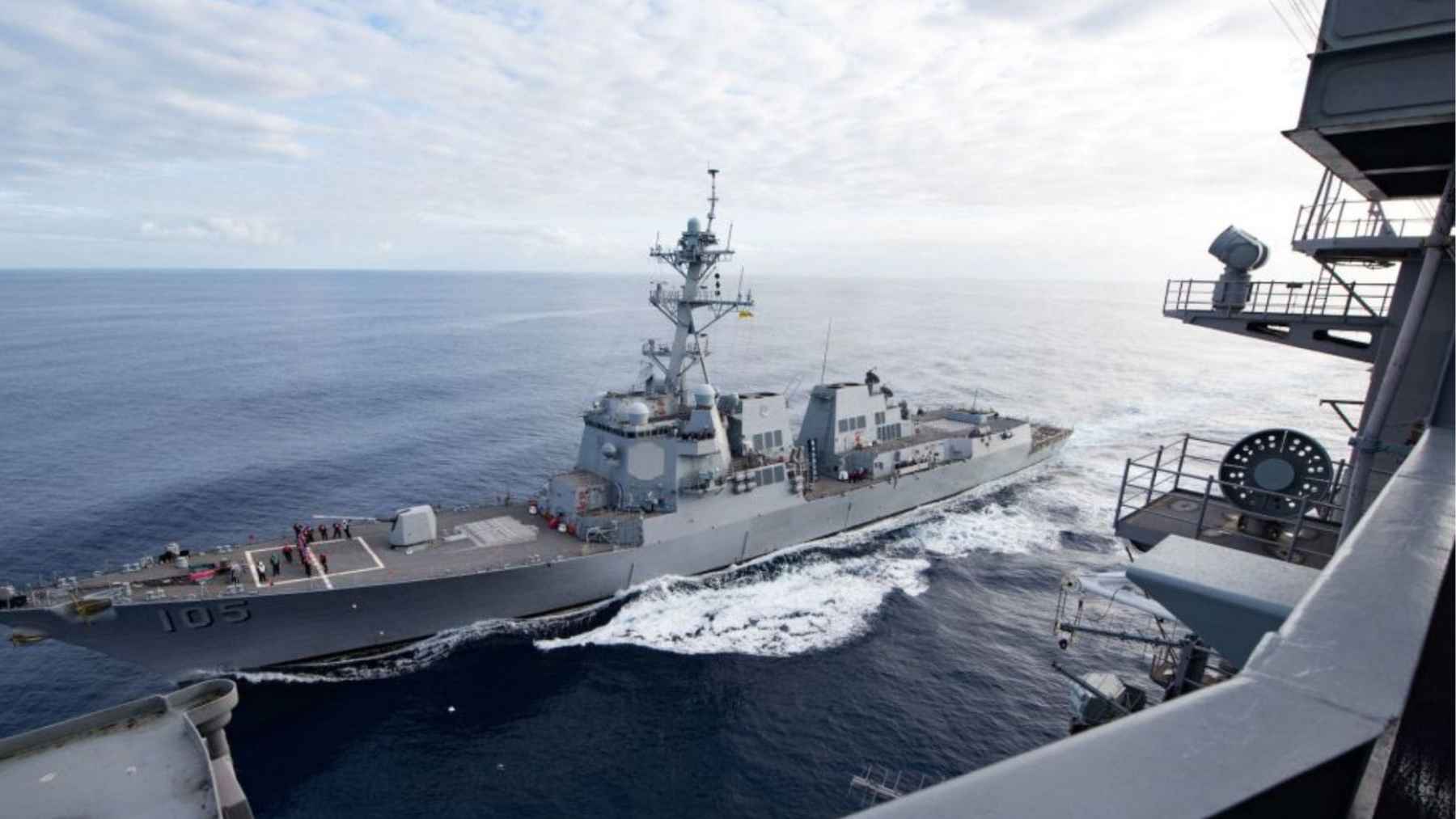 USS Dewey destroyer docked in Singapore with visible rust streaks along its gray hull