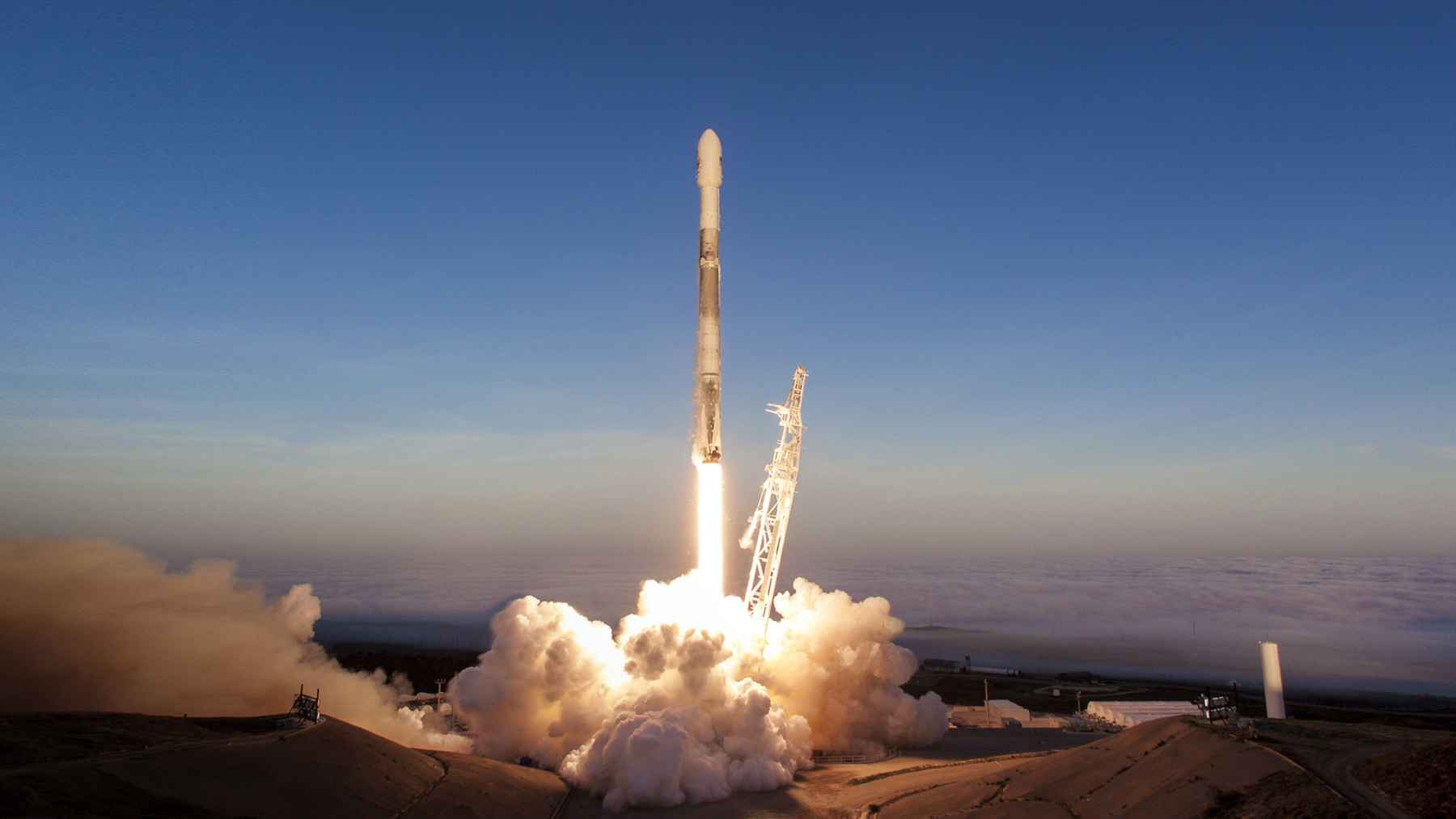 SpaceX Falcon 9 rocket launching at dawn, illustrating new research into water-based space fuels for future missions.