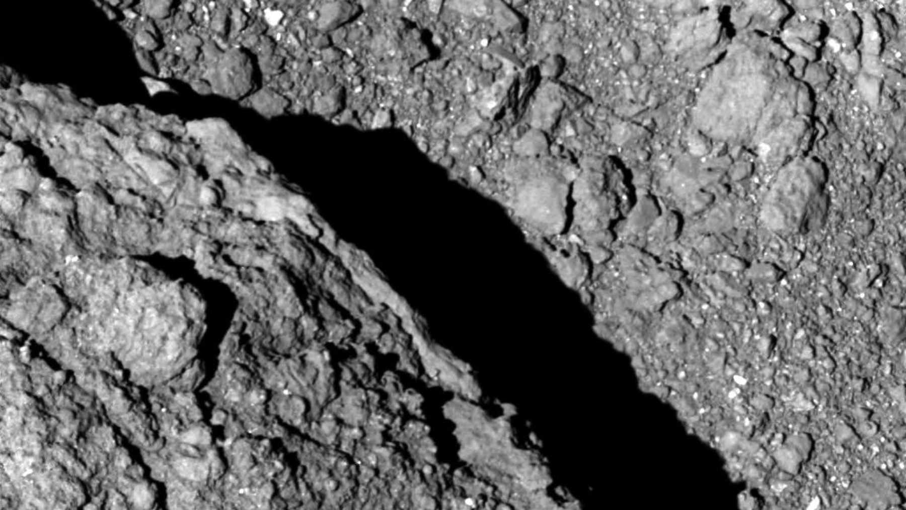 A close-up view of pristine, dark rocky grains collected from the surface of the near-Earth asteroid Ryugu.