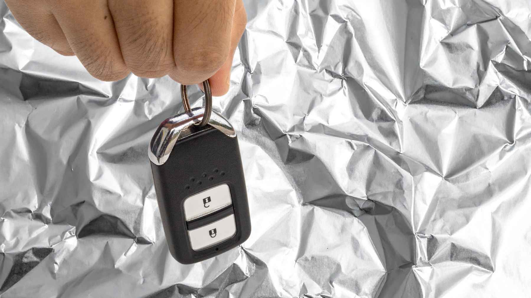 Car key fob wrapped in aluminum foil to block wireless signals and prevent relay theft attacks