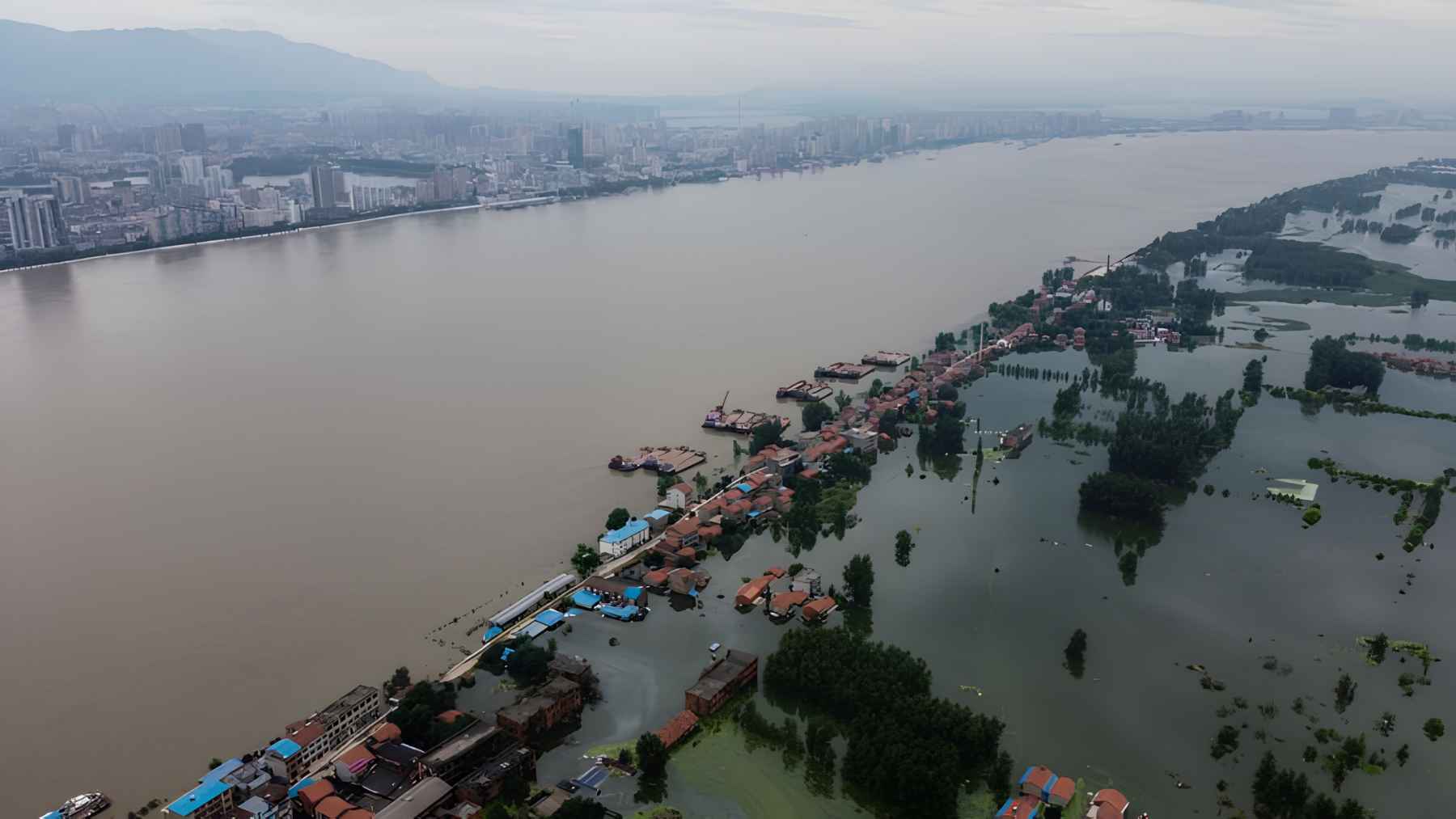 Floodwater surrounds homes in China as rising river levels and coastal flood risks threaten low-lying communities.