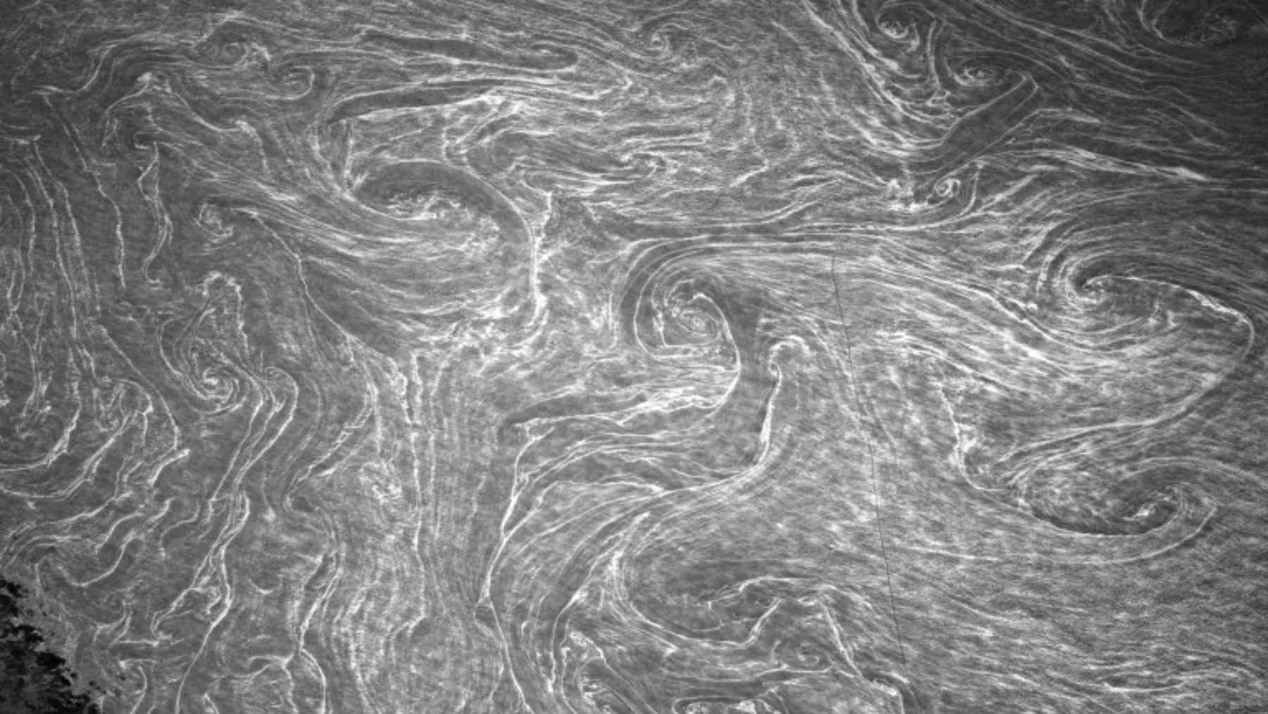 Black-and-white infrared-style view of swirling patterns on the Mediterranean Sea photographed from the International Space Station by NASA astronaut Don Pettit.