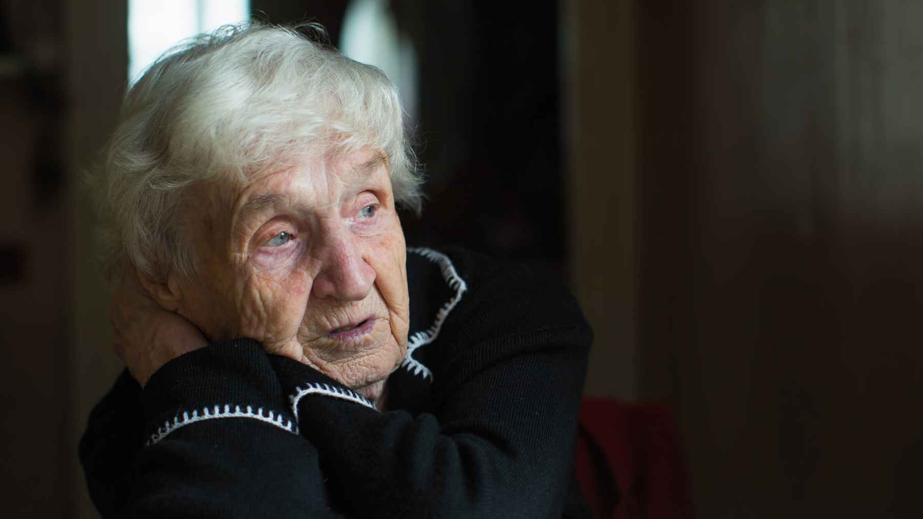 Older adult sitting alone reflecting on fading friendships and one-sided relationships.