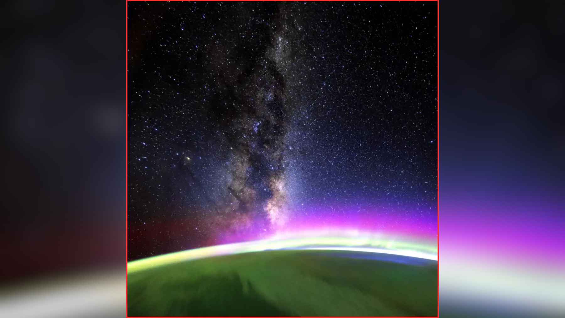 View from the International Space Station showing the Milky Way above Earth’s glowing green and purple aurora along the horizon.