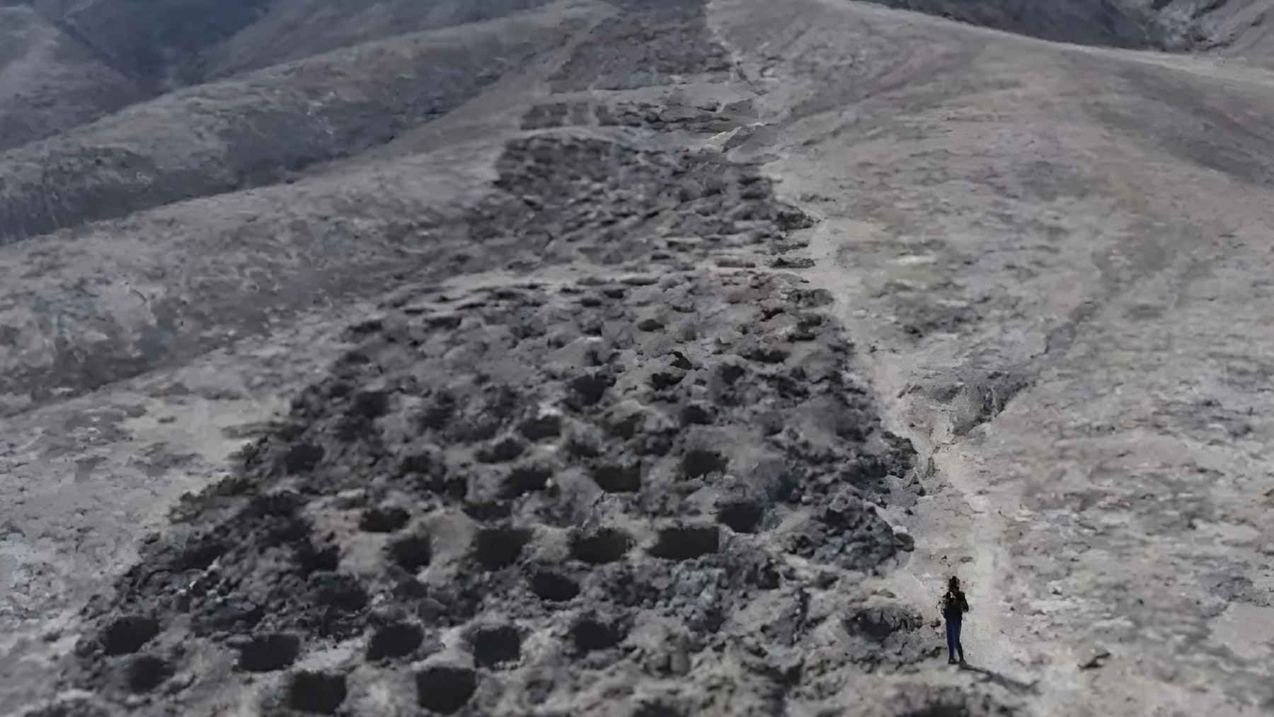 Aerial view of Monte Sierpe in Peru showing thousands of carved holes aligned along a mountain ridge, linked to ancient trade