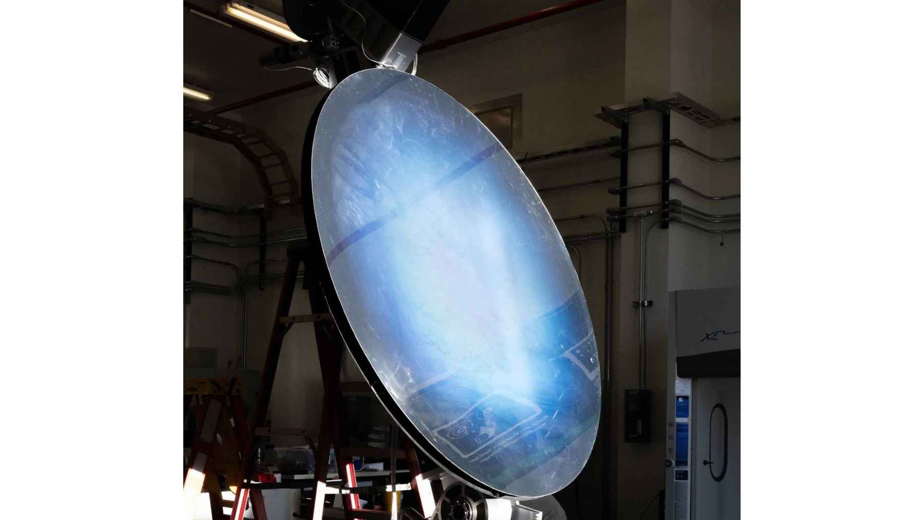A large, circular precision mirror used as a solar concentrator in NASA's Carbothermal Reduction Demonstration experiment.