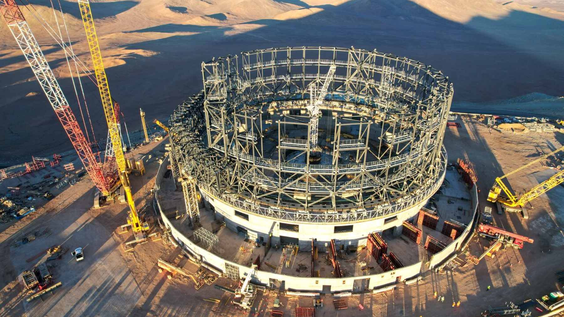A long-exposure photograph of the Milky Way stretching over the domes of the Very Large Telescope at Paranal Observatory in the Atacama Desert.