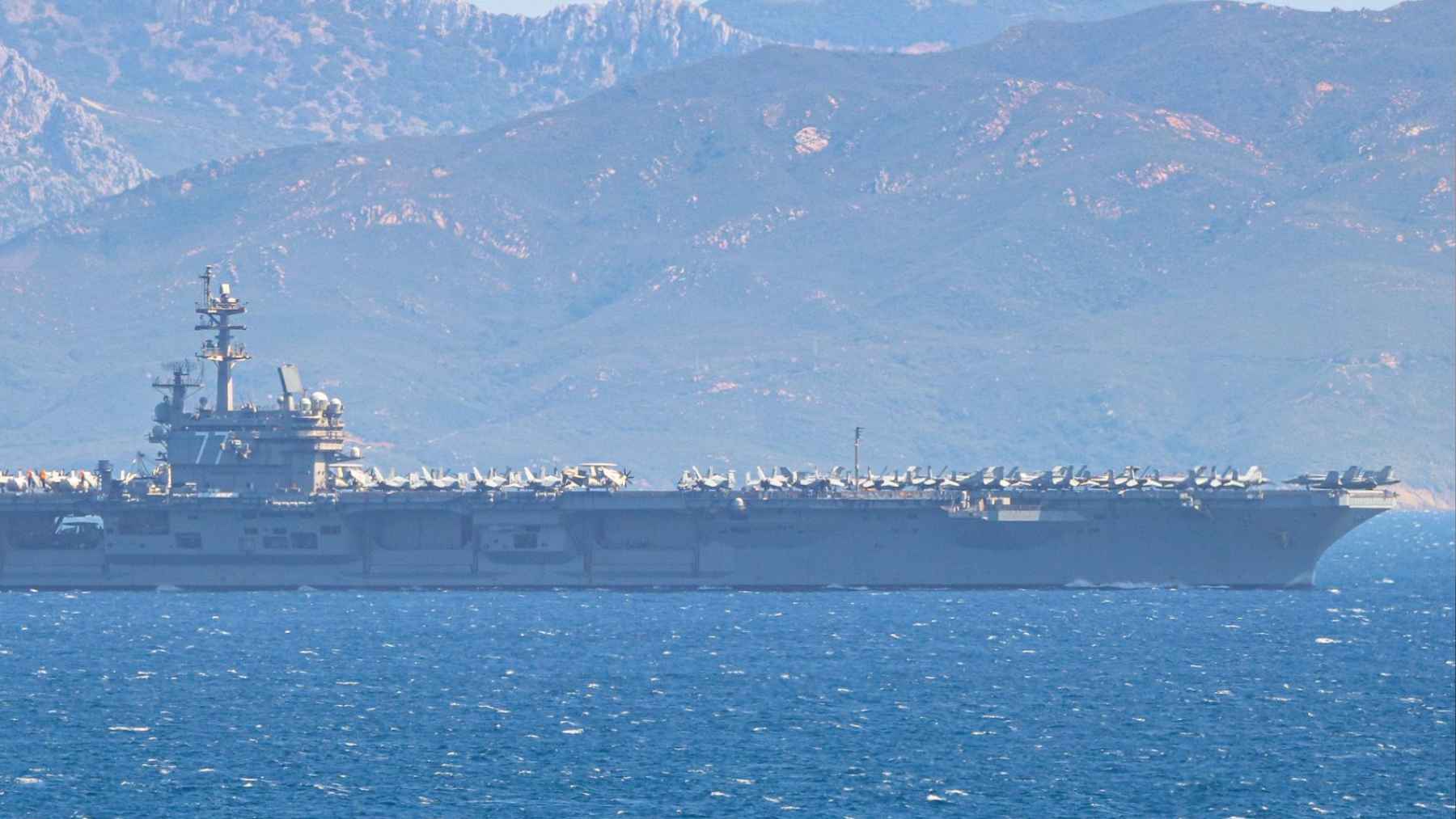 A nuclear-powered aircraft carrier named after George H. W. Bush returns from the Atlantic after completing key maneuvers, and the maneuver once again puts the spotlight on a decisive phase before deployment 1 USS George H W Bush aircraft carrier sailing near mountainous coastline during return from Atlantic training