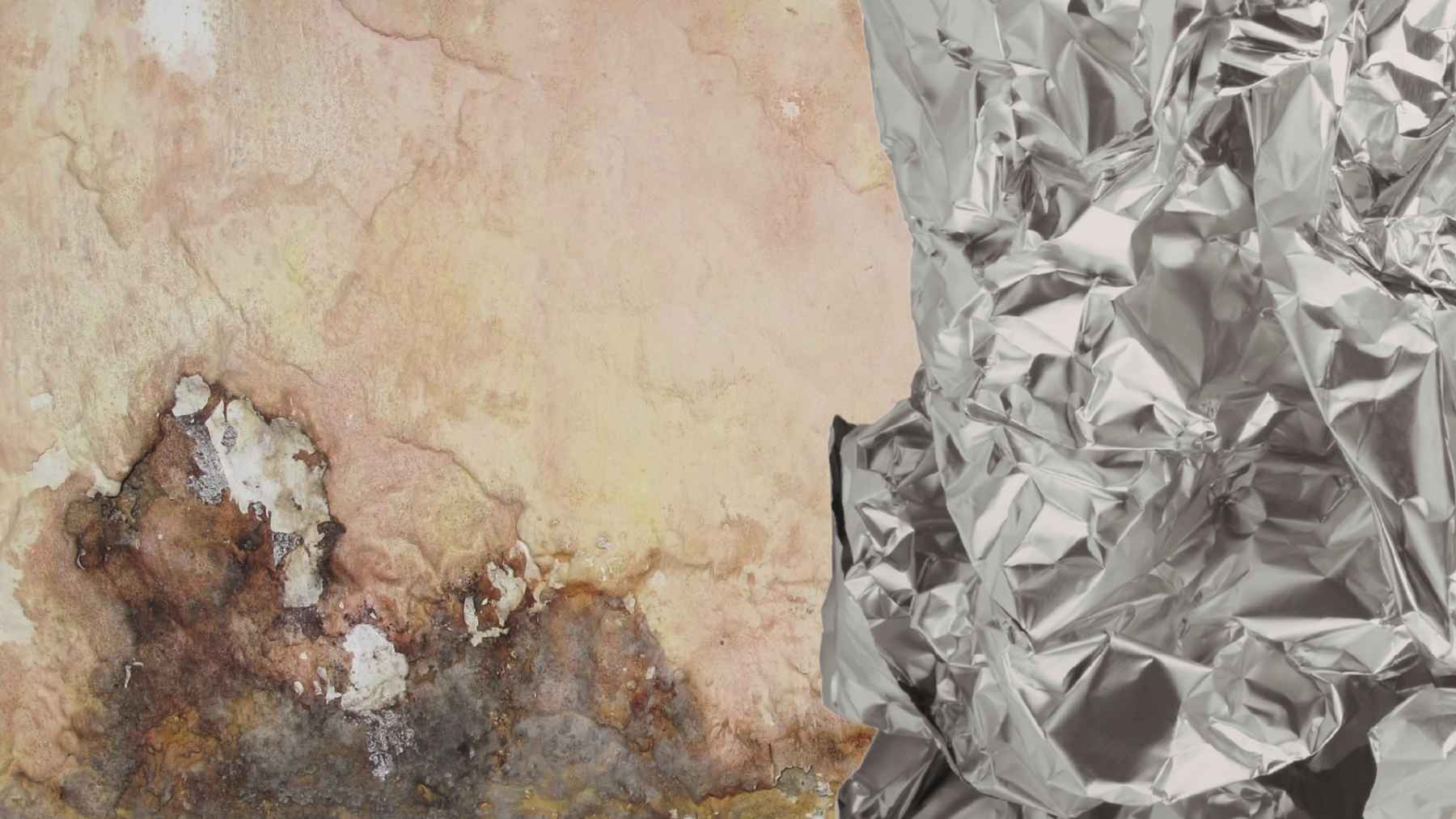 Aluminum foil taped to a wall to test for hidden moisture, leaks, or indoor condensation problems