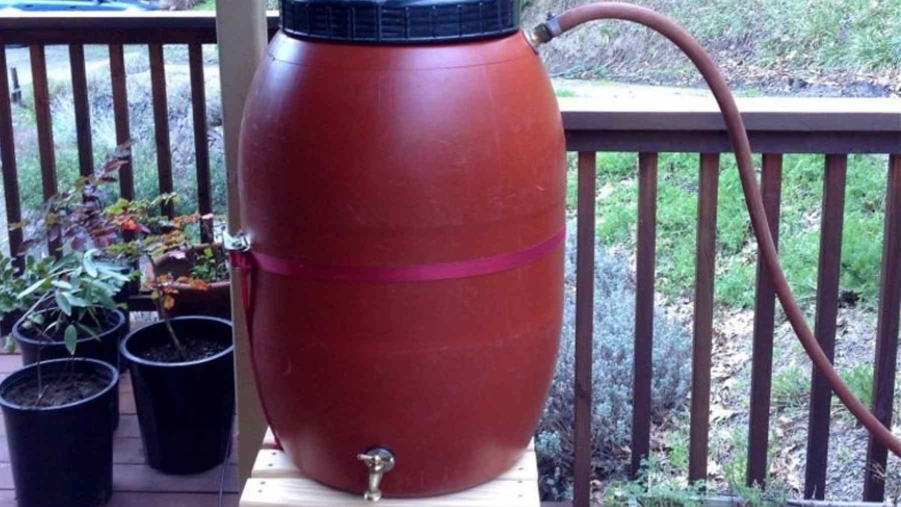 Rain barrel on a home deck used to collect stormwater and help reduce urban flooding in Camden, New Jersey