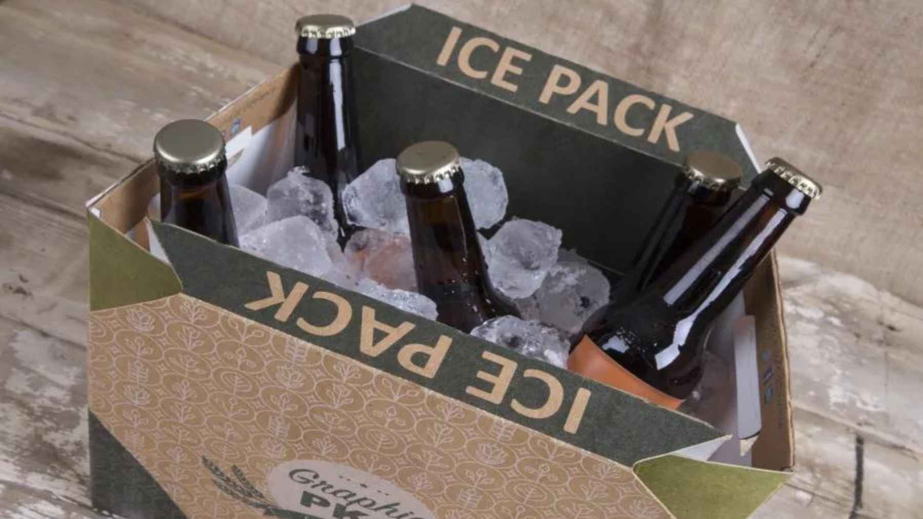 Cardboard cooler box filled with ice and beer bottles, designed to keep drinks cold using a recyclable insulated structure.
