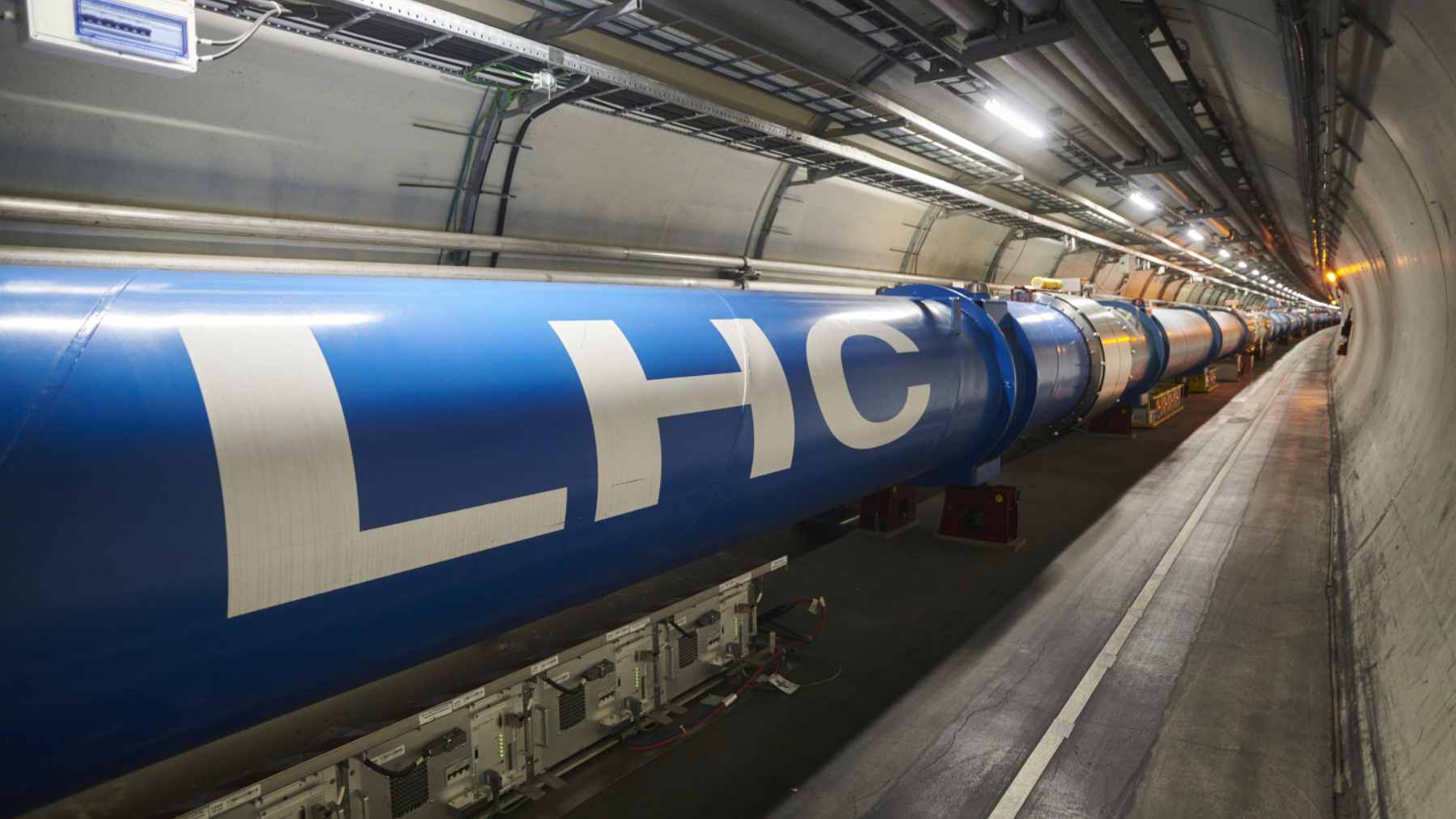With a 17-mile ring buried as deep as 574 feet under the French-Swiss border, the world’s largest particle accelerator is an underground “city” built to push physics to its limit 1 A view inside the Large Hadron Collider’s tunnel, showing the 17-mile ring of superconducting magnets used for particle collisions.