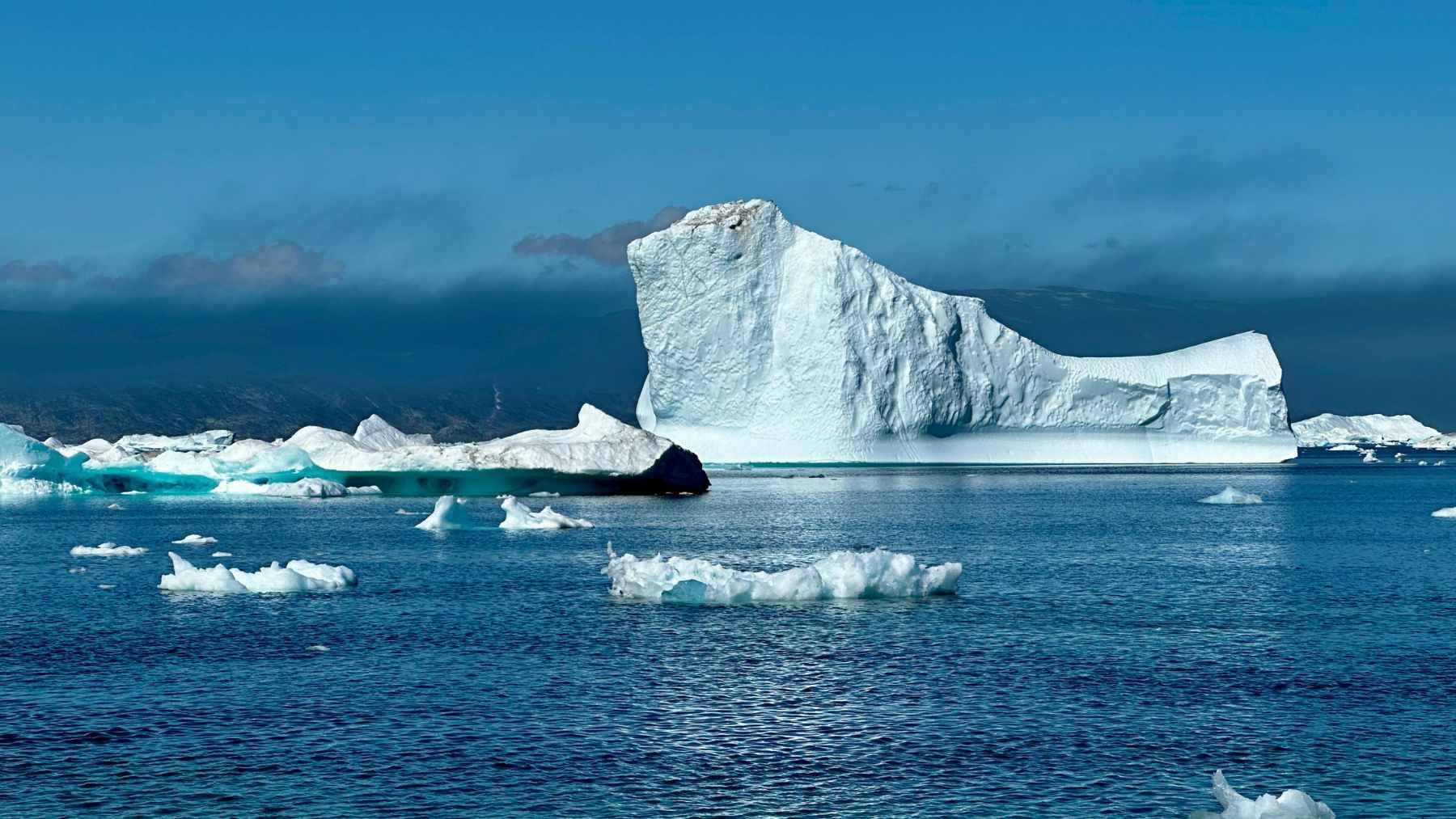 Aerial view of meltwater runoff forming rivers on the surface of the Greenland Ice Sheet during an extreme heat event.