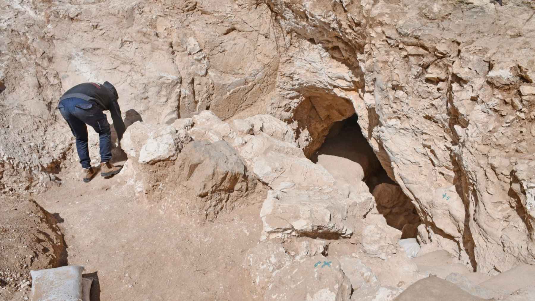 Archaeologist inspects entrance of a rock-cut underground tunnel discovered near Ramat Rachel in Jerusalem.
